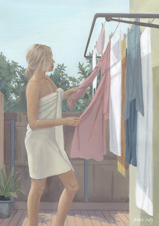 Woman hanging clothes on a line outdoors