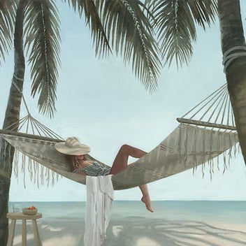 Person relaxing in a hammock under palm trees by the ocean