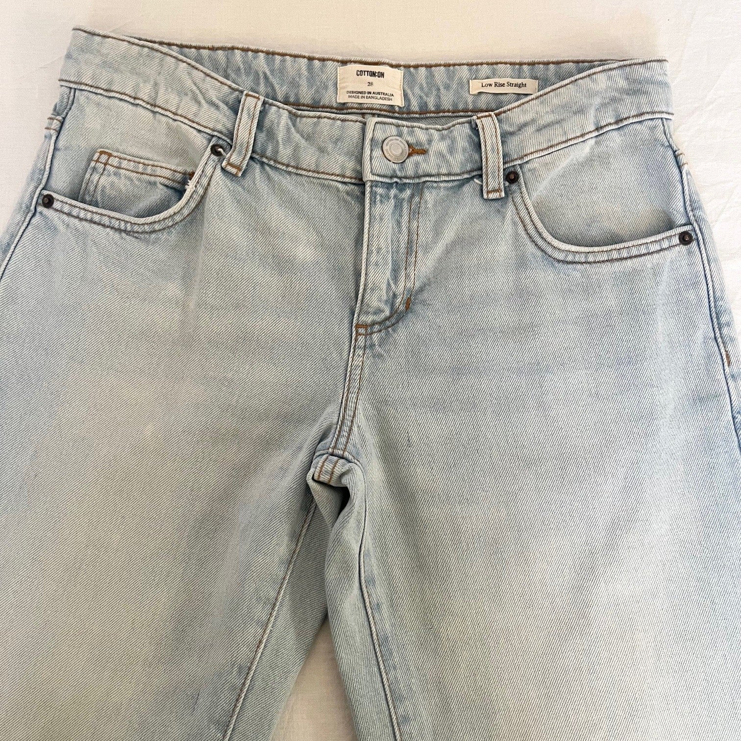 Light blue jeans on a beige background