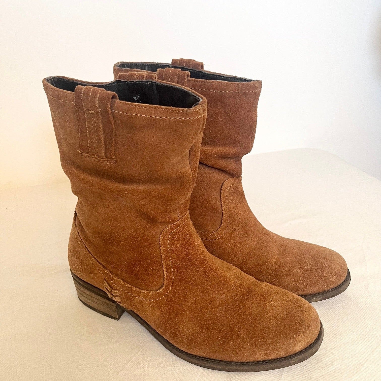 Pair of brown suede boots on a white background