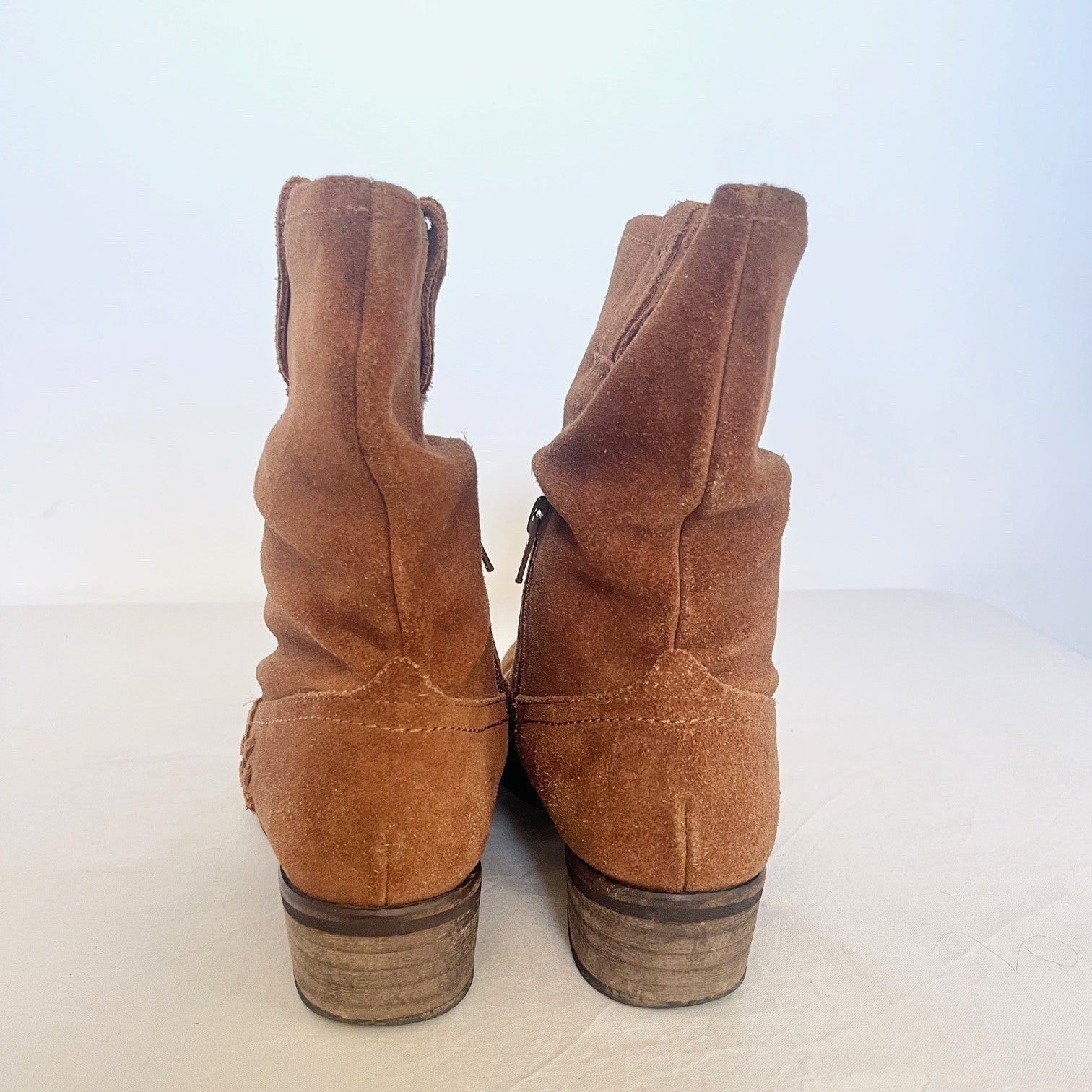 Pair of brown suede boots on a white background