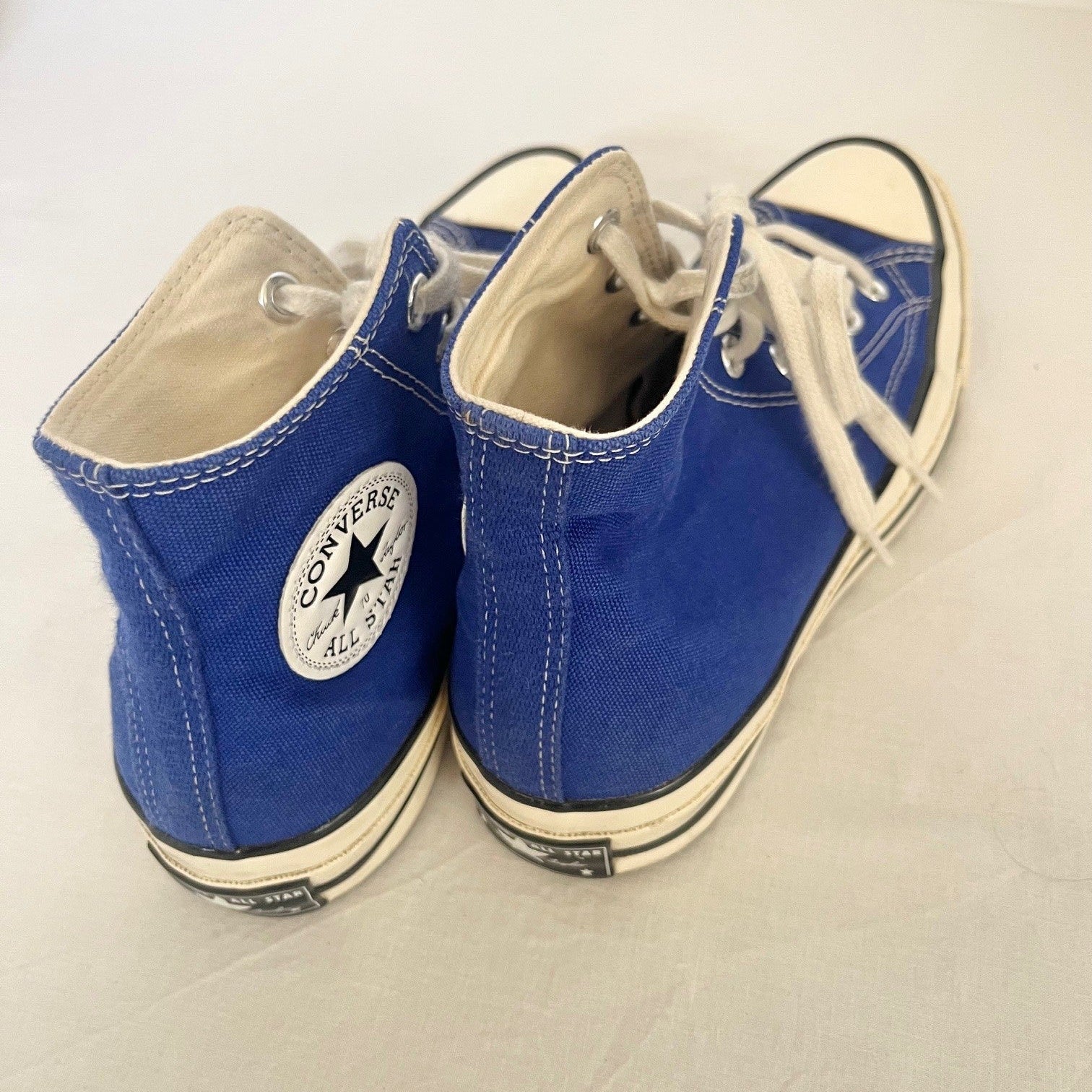 Pair of blue Converse sneakers on a light background