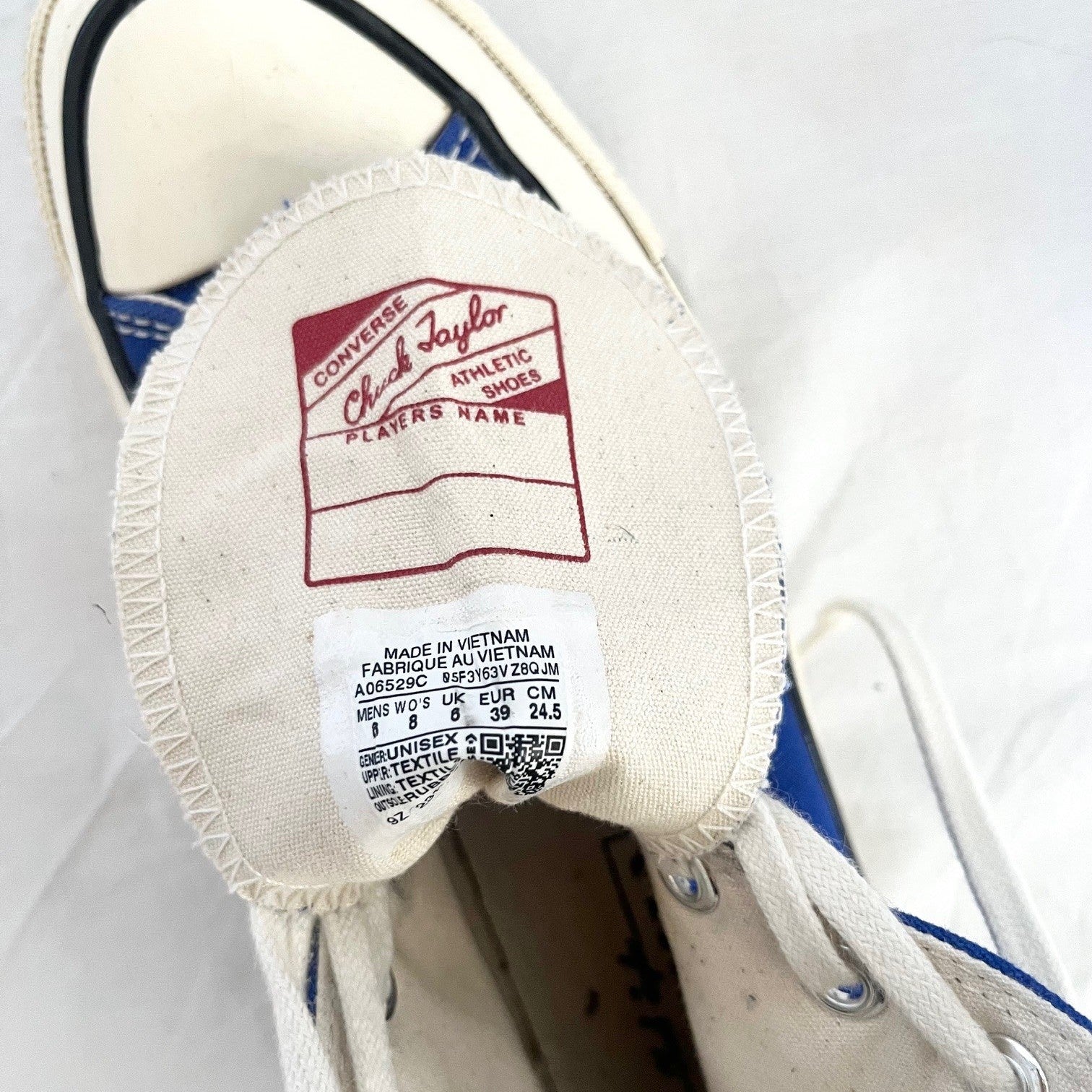 Close-up of a Converse shoe label on a white background