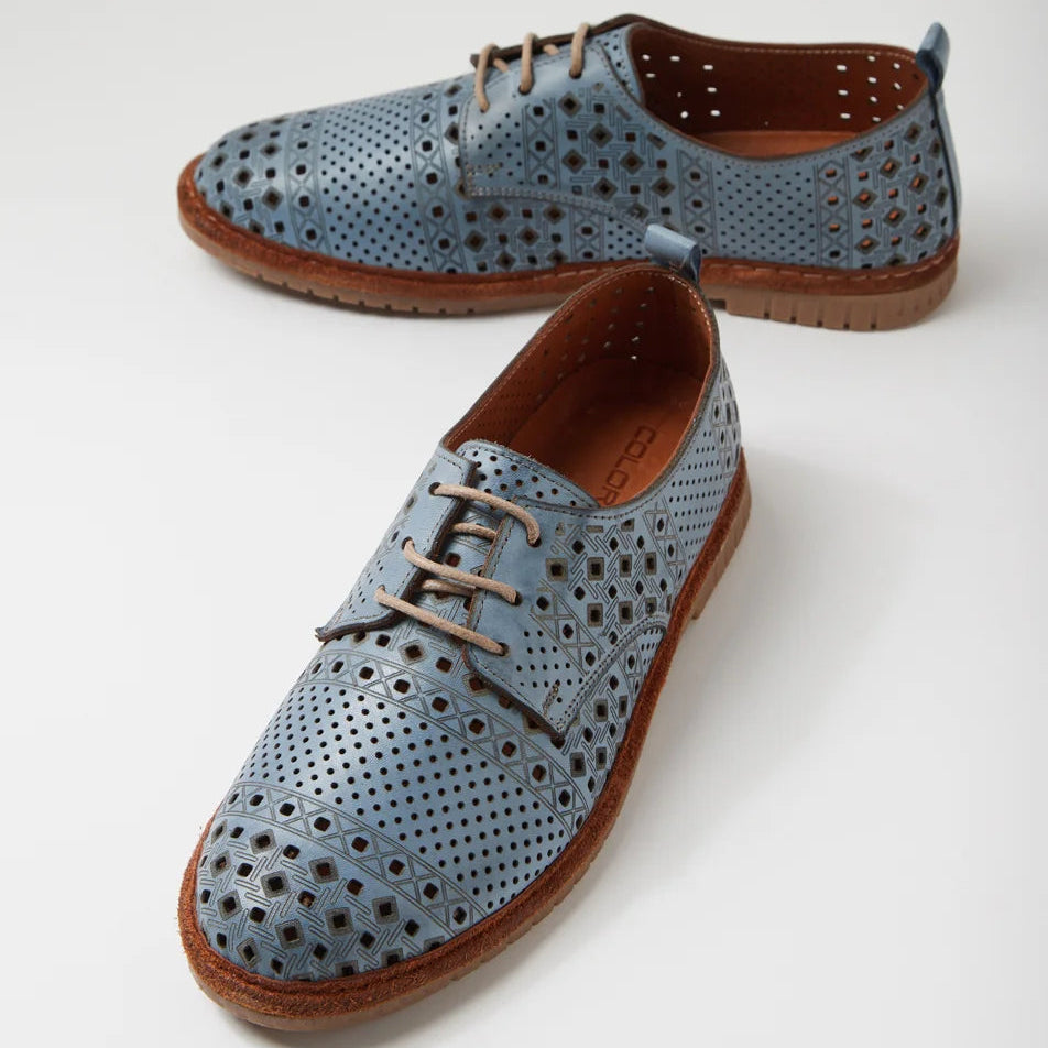 Pair of blue perforated shoes with brown soles on a white background