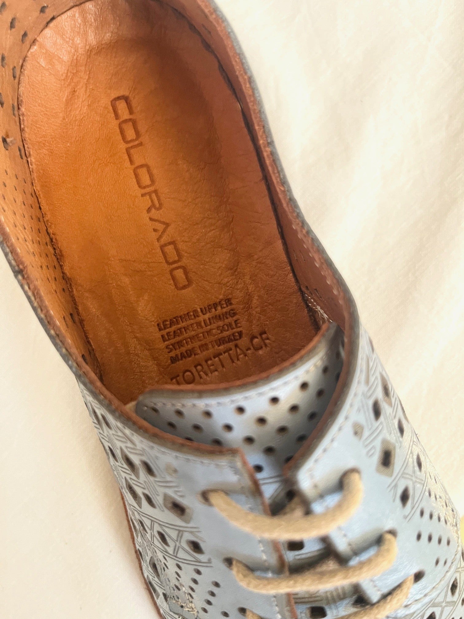 Close-up of a shoe with 'Colorado' branding on the sole.